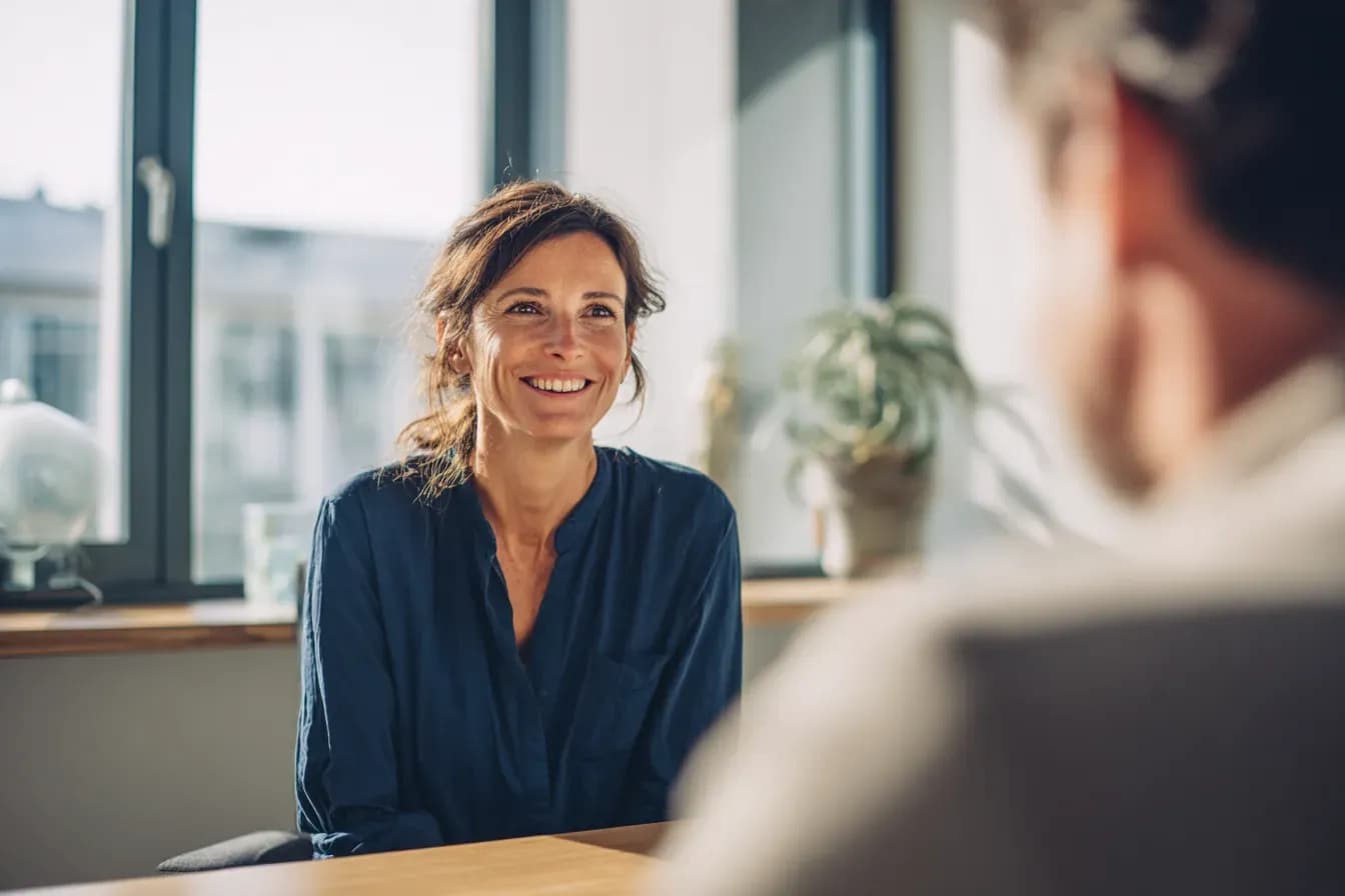 A woman smiling during an in-person care consultation